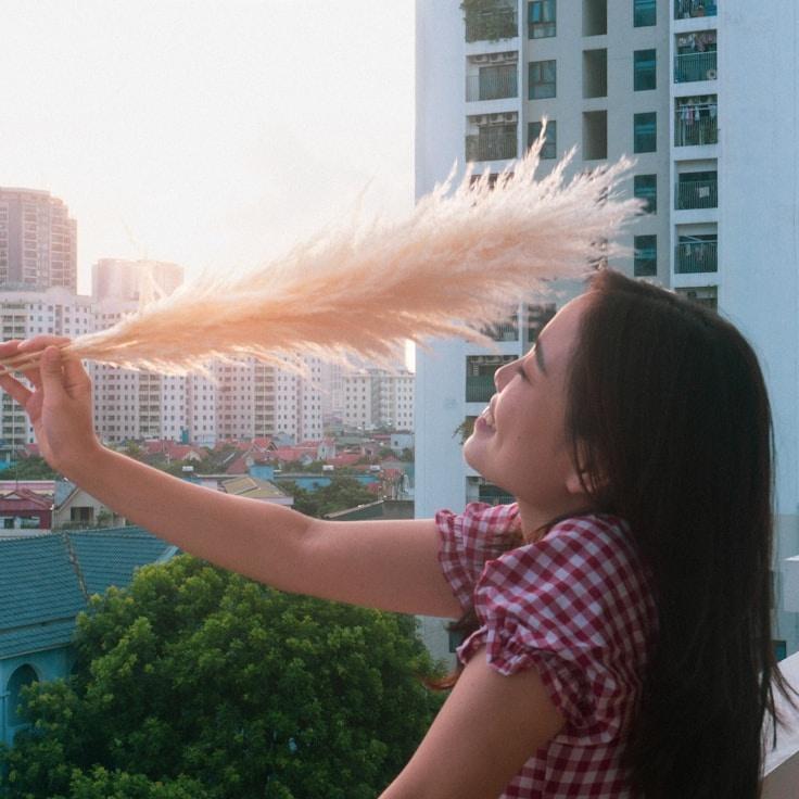 Avery Chen, Lead Design Curator at River Crest Soft, reviewing corporate floral arrangements